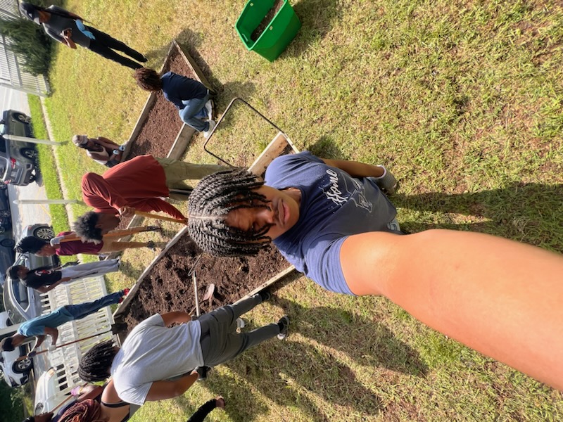 Devin Minor volunteering with Aggies Go Green during a community gardening activity